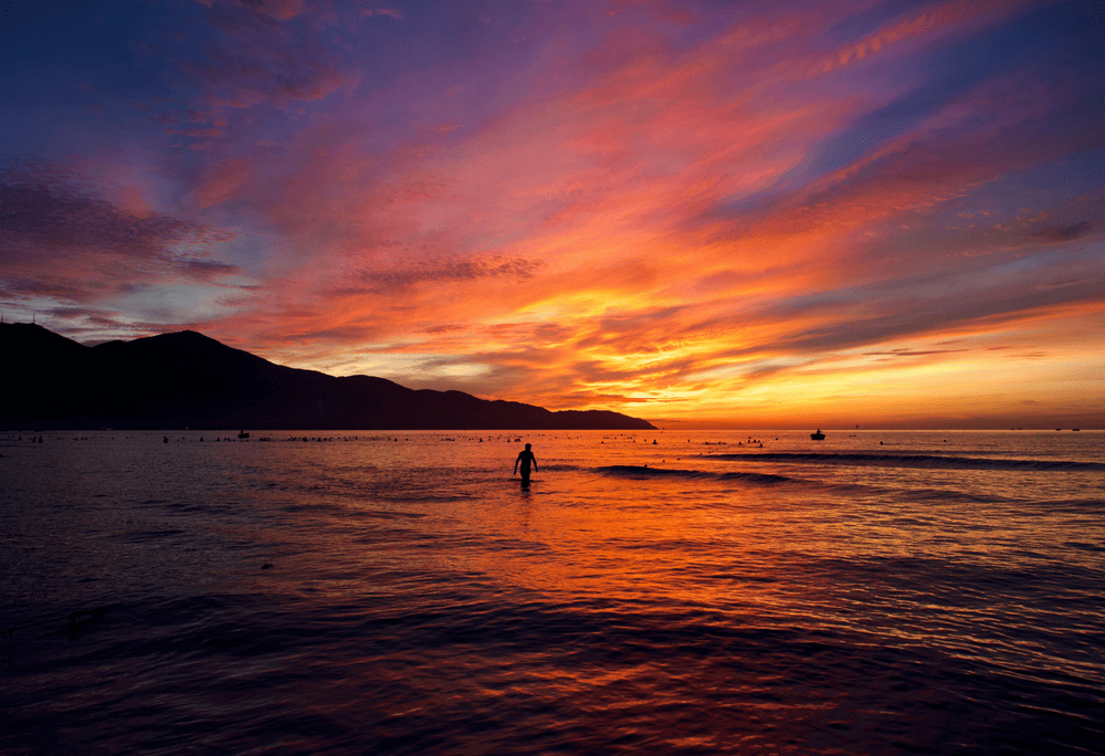 As the sun sets, fishing boats slowly make their way back to shore after a long day out at sea (Source: Canva)